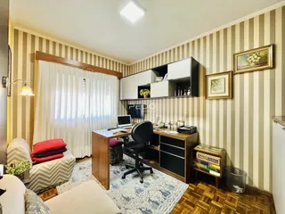 Sala de estar com decoração de parede listrada e piso de madeira.