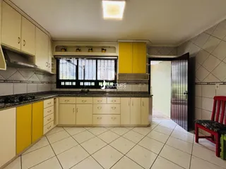 Foto de uma cozinha com armários amarelos e piso branco.