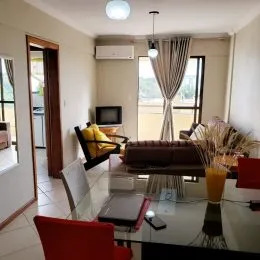 Foto de uma sala de estar com piso de cerâmica e móveis.