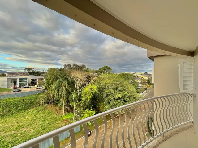 Vista da varanda mostrando vegetação e paisagem da região.