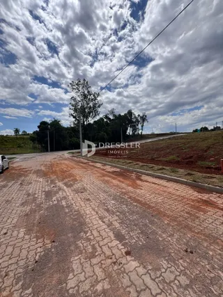 Vista da estrada de terra em Lajeado, Brasil, com vegetação ao fundo.