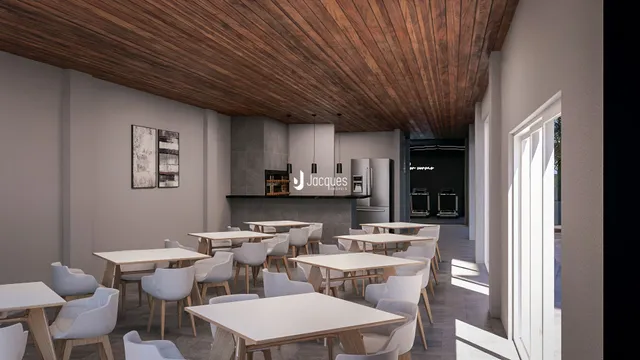 Uma sala de jantar longa com mesas e cadeiras brancas em um ambiente com teto de madeira.