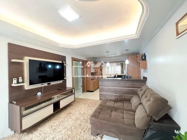 Sala de estar com móveis de madeira e televisão.