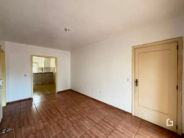 Corredor interno com piso de cerâmica em tom terracota.