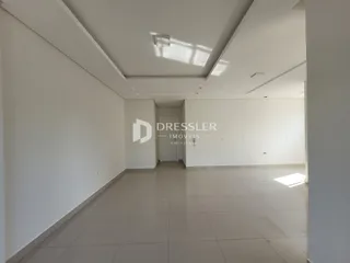 Hall de entrada longo com piso de cerâmica claro.