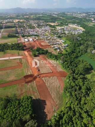 Vista aérea de uma área de terra com vegetação e trilhas no Brasil.