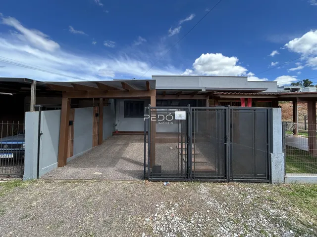 Fachada da casa residencial em Lajeado, Brasil, com portão de segurança.