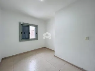 Vista interna de um cômodo com paredes brancas e piso de cerâmica.