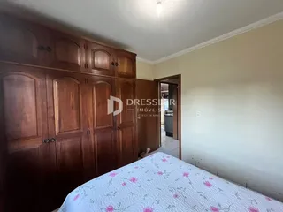 Quarto com armários de madeira e cama na sala.