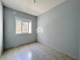 Foto de um cômodo interno com paredes cinzas e piso de cerâmica.