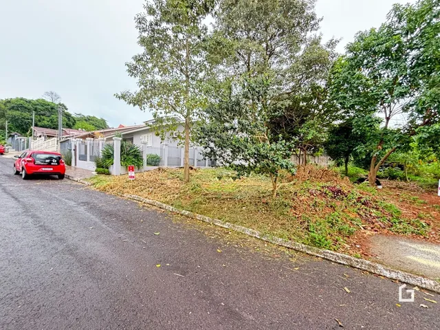 Vista da fachada de uma residência em Lajeado, Brasil, com vegetação densa na frente.