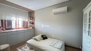Quarto com cabeceira e janela em um imóvel no Brasil.