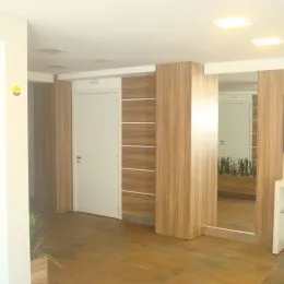 Hall de entrada com revestimento de madeira nas paredes.