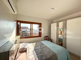 Quarto com janela de madeira e cama no imóvel.
