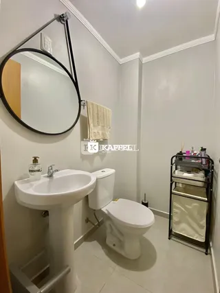 Este é um banheiro com pia, vaso sanitário e espelho.