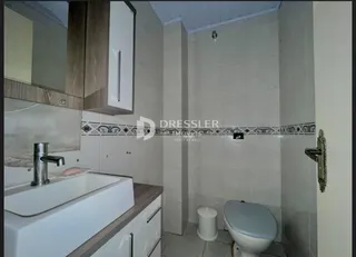 A foto mostra o interior de um banheiro com azulejos brancos.