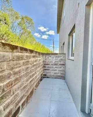 Parede de tijolos e caminho de concreto de uma propriedade em Lajeado.