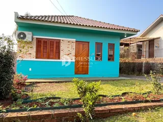 Fachada de uma casa azul em Lajeado, Brasil, com telhado de telhas.