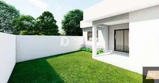 Fachada de uma casa branca com jardim verde.