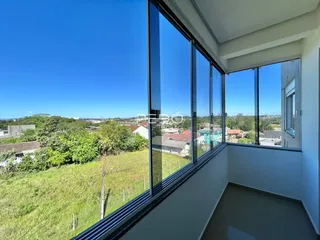 Vista ampla de uma área externa com paisagem verde ao fundo.