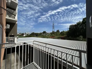 Vista da varanda de um edifício com grade metálica.
