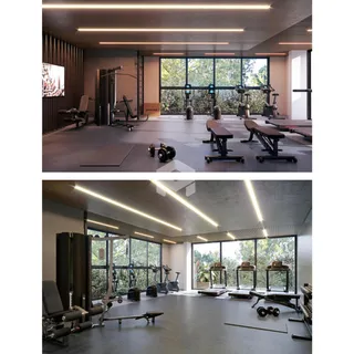 Salão de ginástica moderno com equipamentos de musculação e grandes janelas.