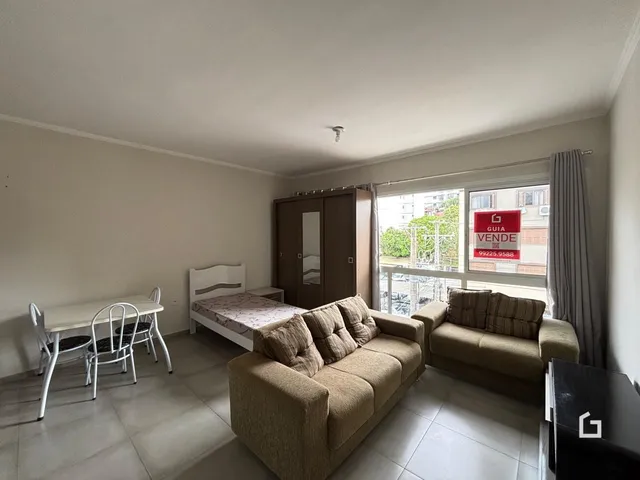 Quarto com cama, armário e sofá em um apartamento no Brasil.