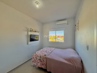 Quarto com cama e janela em um apartamento.