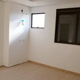 Ambiente interno com paredes brancas e janela visível.
