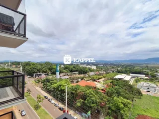 Vista aérea de uma área residencial com ruas e vegetação em Lajeado, Brasil.
