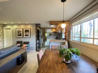 Uma sala de estar com sofá e mesa de madeira em um imóvel.