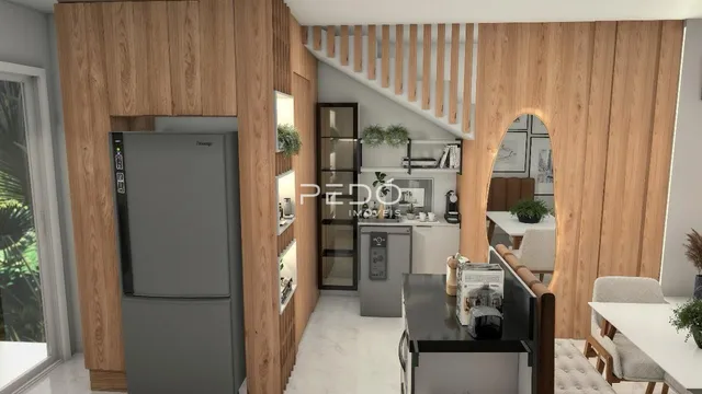 Sala de estar com revestimento de madeira e cozinha moderna.