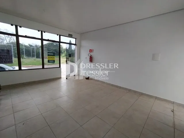 Sala de estar com grandes janelas de vidro em um imóvel no Brasil.