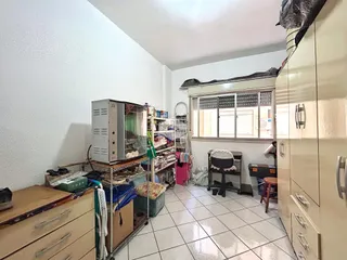Interior de um cômodo com piso de cerâmica e armário grande.