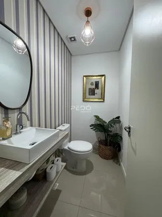 Foto de um banheiro moderno com bancada e vaso sanitário.