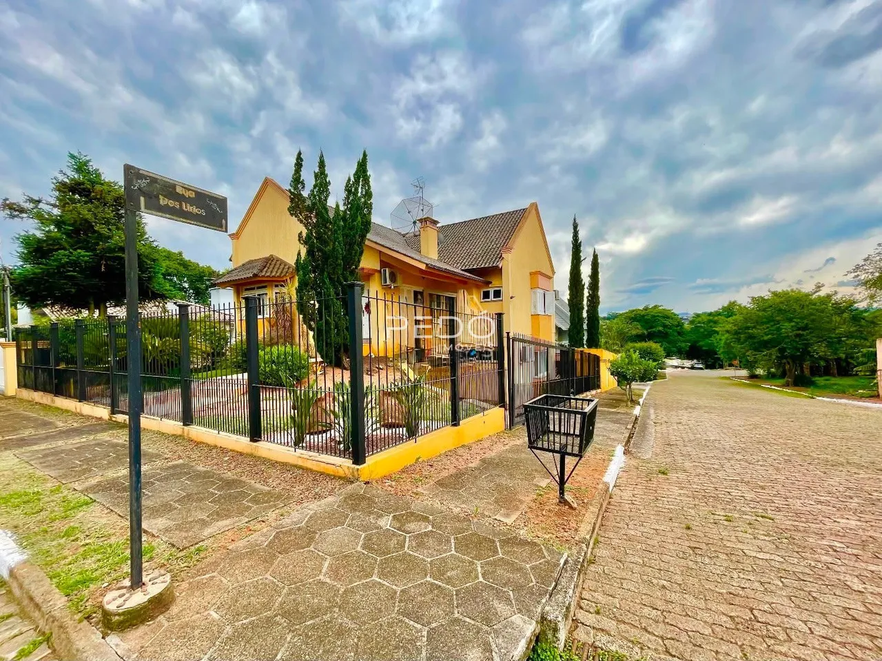 Vista da fachada de uma residência em Lajeado, Brasil, com cerca e jardim.