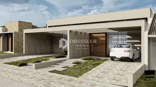 Fachada de uma casa moderna em Lajeado, Brasil, com jardim e área de estacionamento.