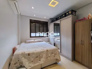 Quarto com cama e guarda-roupa de madeira.