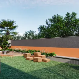 Foto de um jardim externo com vegetação baixa e um muro de contenção.