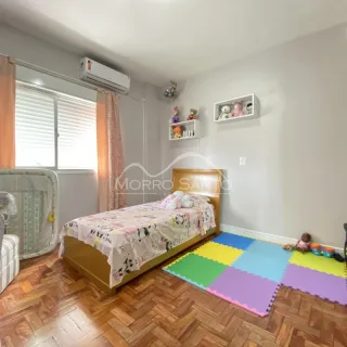Quarto com cama de madeira e piso de madeira.