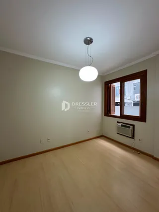Ambiente interno com piso de madeira clara e paredes claras.