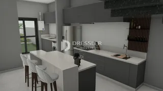 Vista da cozinha moderna com ilha e balcões.