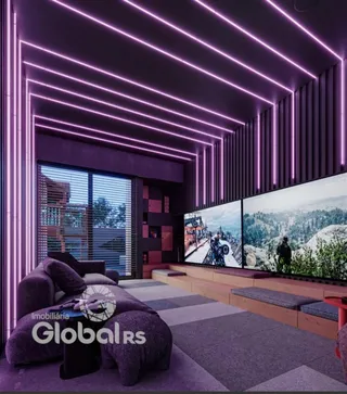 Sala de estar moderna com iluminação de LED e grandes televisores.
