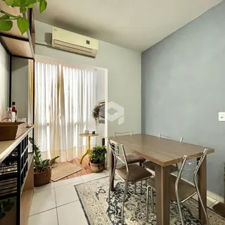 Uma sala de jantar com mesa de madeira e janela em um imóvel no Brasil.