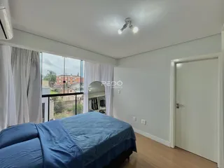 Quarto com cama e vista da janela.