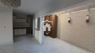 Ambiente interno de uma sala com piso de cerâmica e paredes brancas.