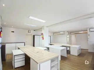 Interior de um espaço aberto com cozinha e sala de jantar.