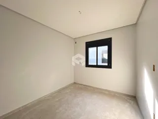 Foto de um ambiente interno com paredes brancas e piso claro.