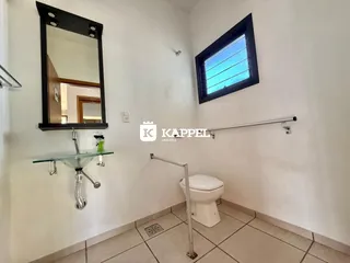 Foto de um banheiro com piso de cerâmica e espelho na parede em uma propriedade em Lajeado.