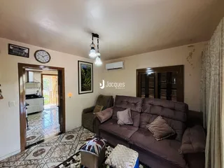 Sala de estar com sofá e portas de madeira em uma residência.